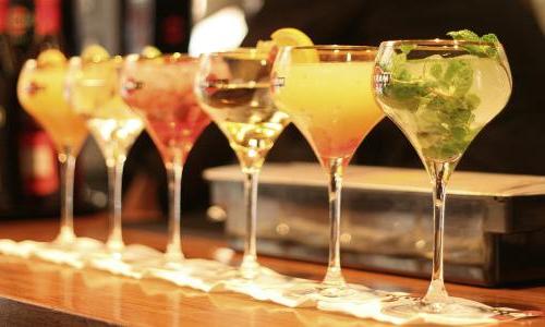 A row of cocktails on a bar