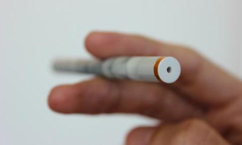 E-cigarette held between someone's fingers